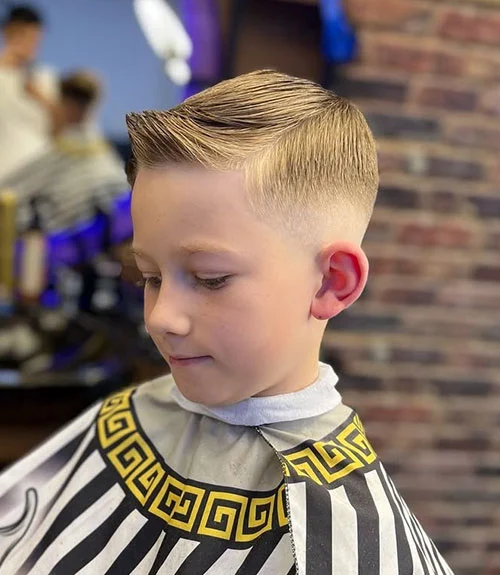 35 Popular Boy’s Haircuts Trending in 2025 (Cool & Stylish Ideas for All Ages) 30 This image has an empty alt attribute; its file name is Formal-Side-Swept-Style-with-Mid-Fade.webp