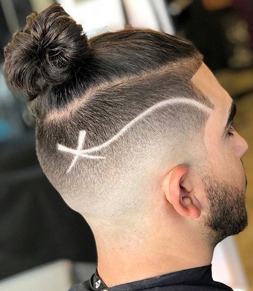 30 Haircut Designs That Match Your Style (Cool, Creative & Modern Looks) 28 Man Bun with Undercut Fade and Artist Design